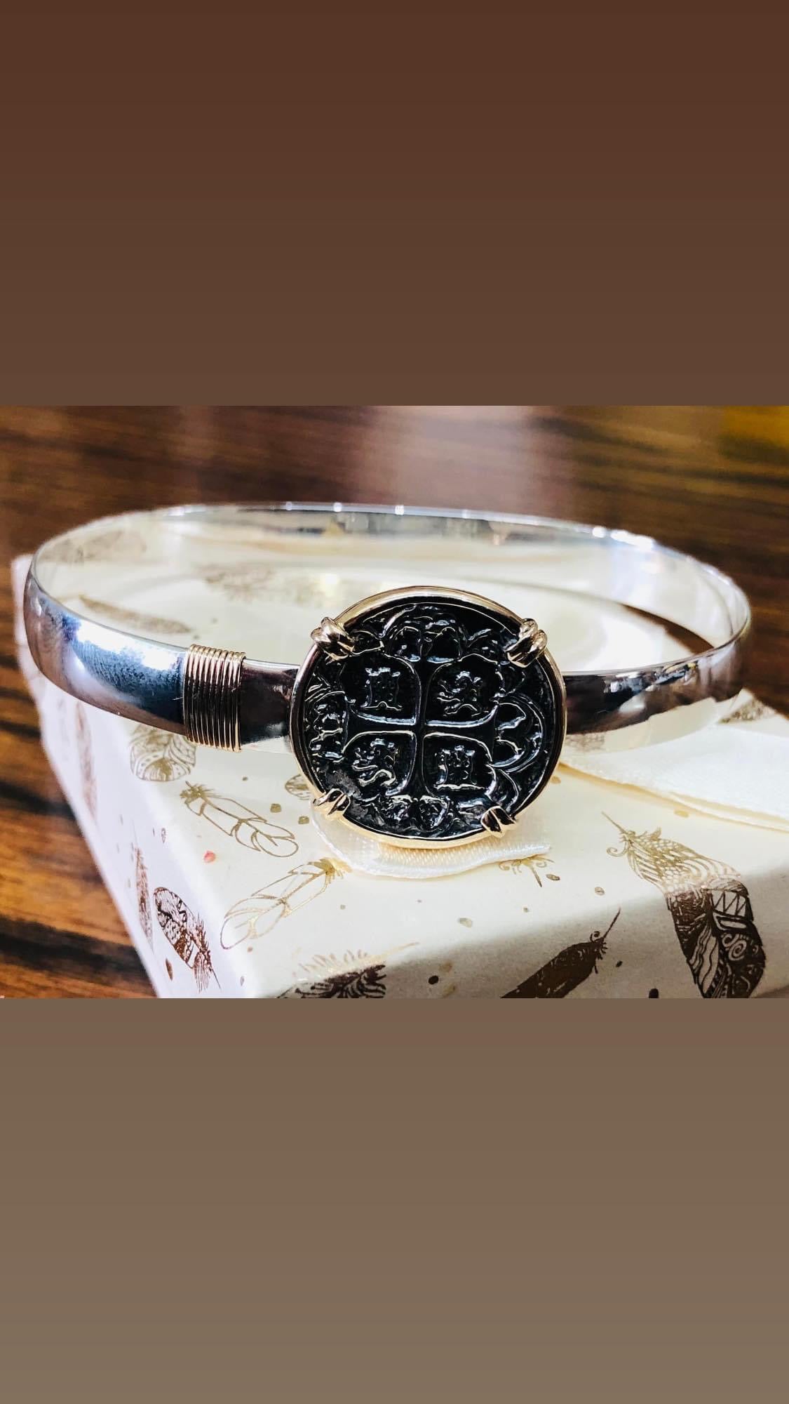 14 k gold framed with sterling silver wire coin bracelet.