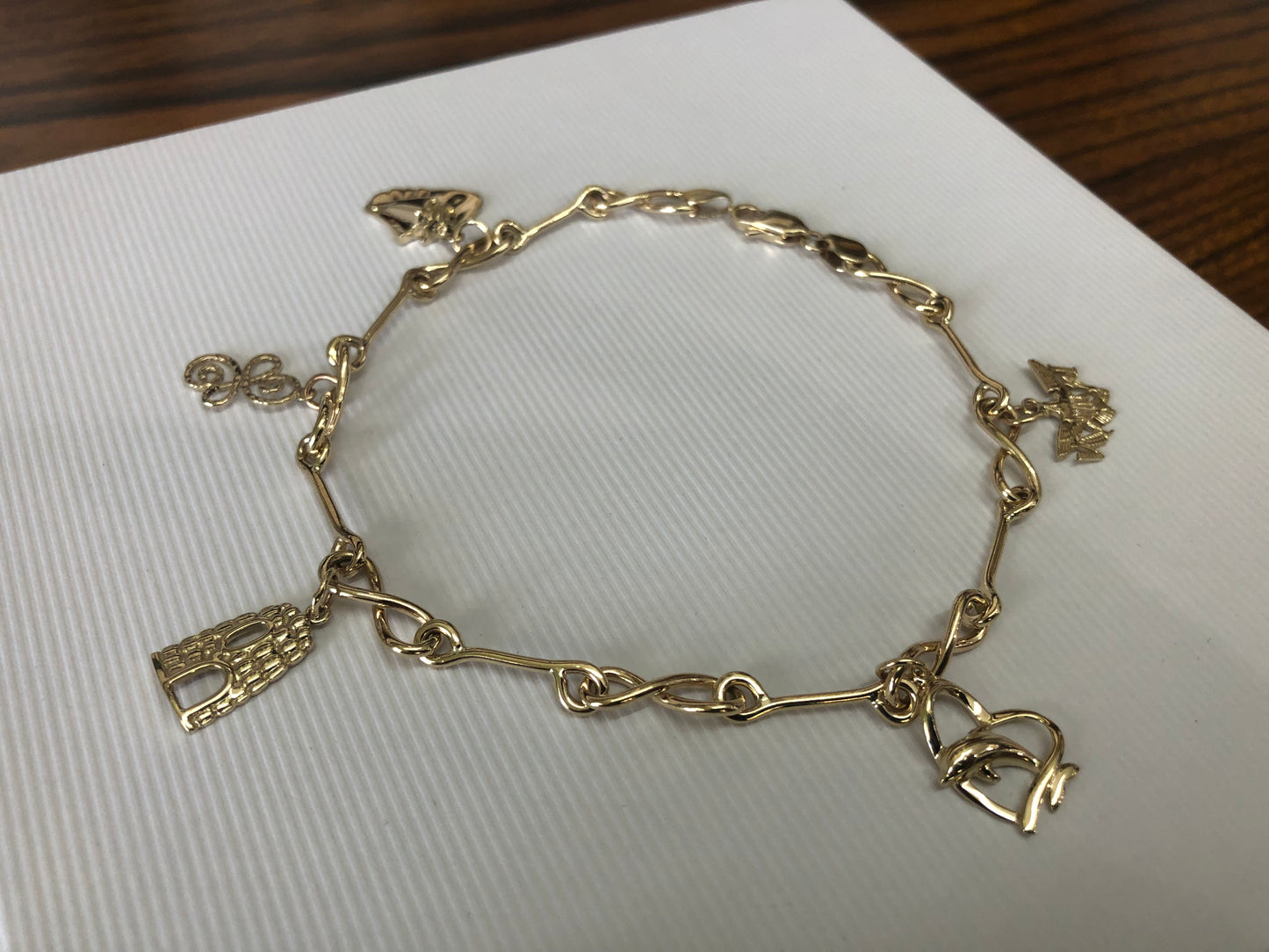 Solid 14 k gold and 10 k gold charms anklet.