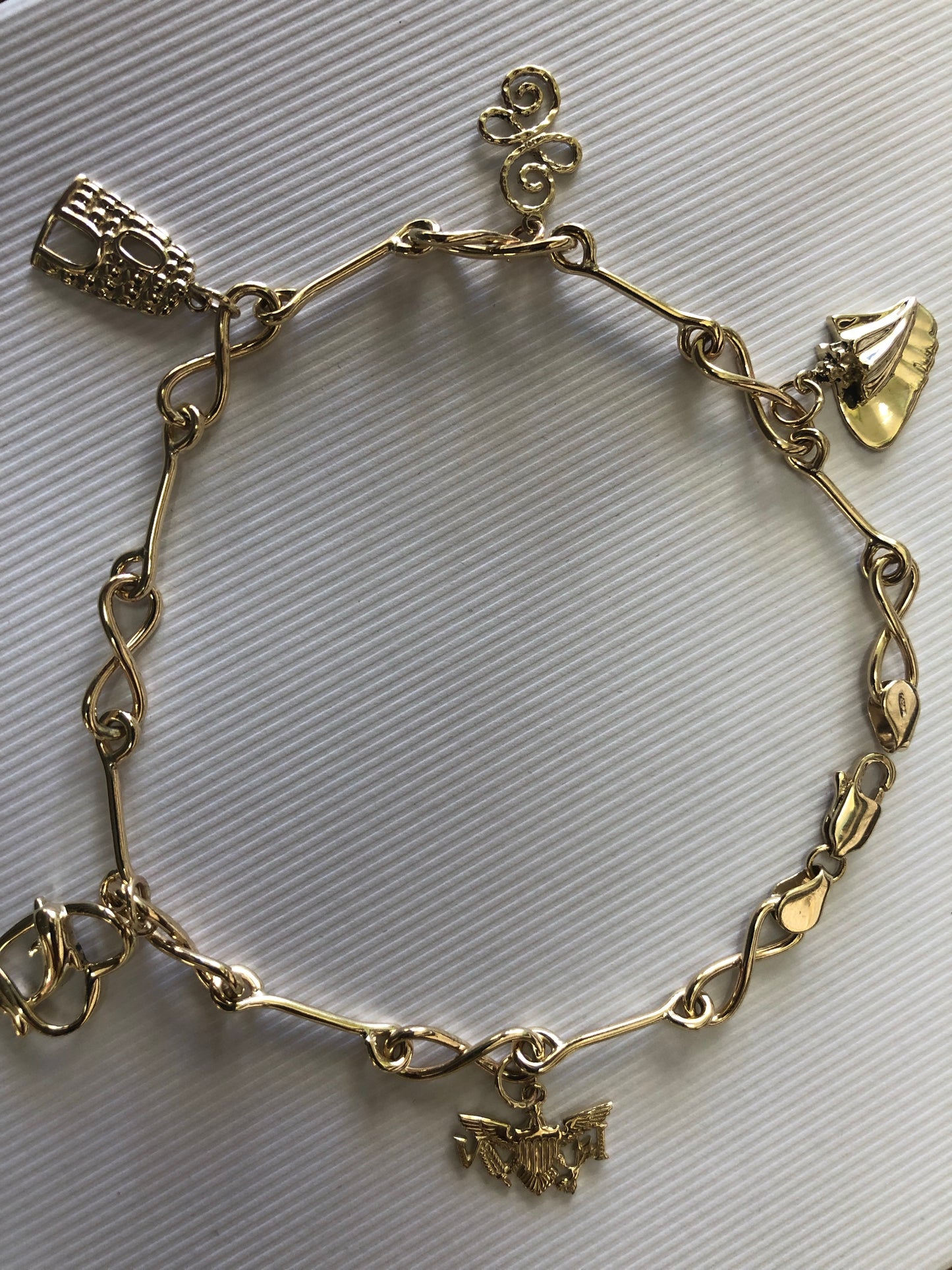 Solid 14 k gold and 10 k gold charms anklet.