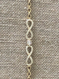 Double infinity gold plated hand chain 7 1/2 inches.