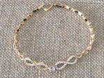 Double infinity gold plated hand chain 7 1/2 inches.